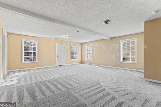 interior space with baseboards, carpet, and a textured ceiling