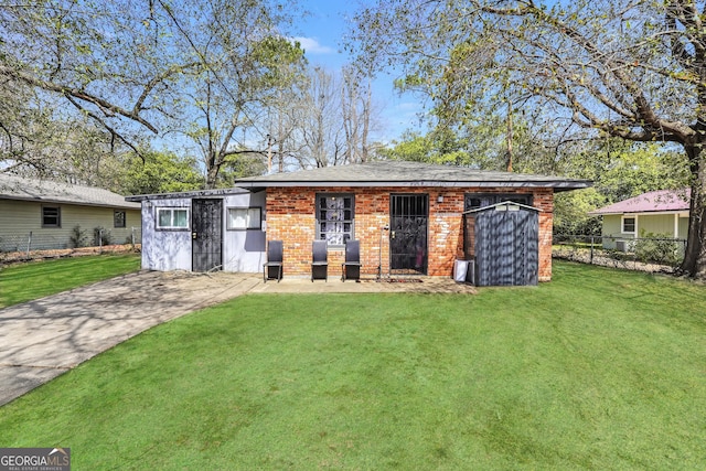 view of outbuilding featuring driveway and fence