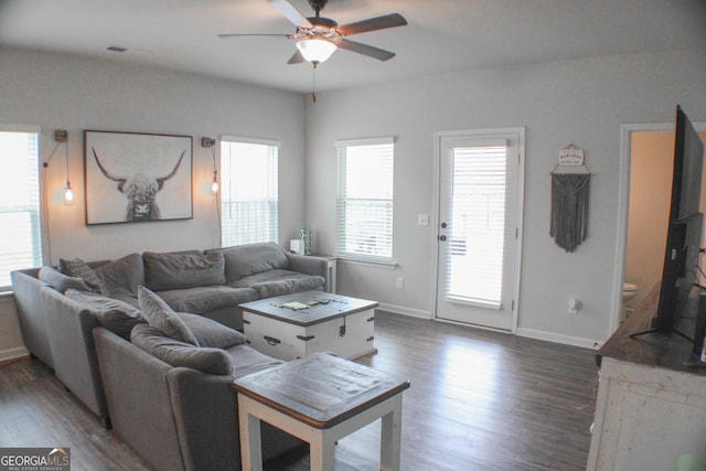 living room with baseboards, a ceiling fan, and wood finished floors