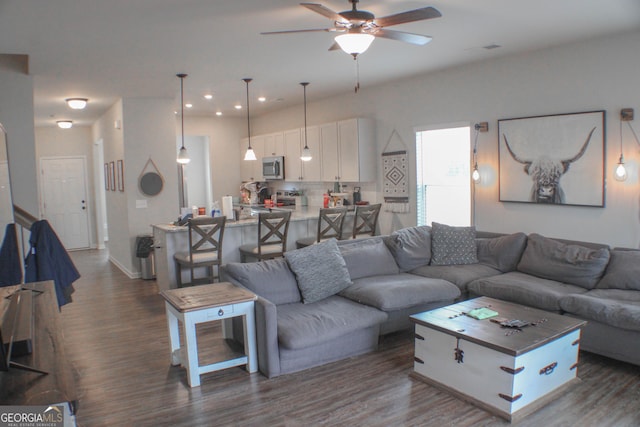 living area with dark wood-style floors, recessed lighting, a ceiling fan, and baseboards