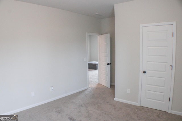 unfurnished bedroom with baseboards and carpet