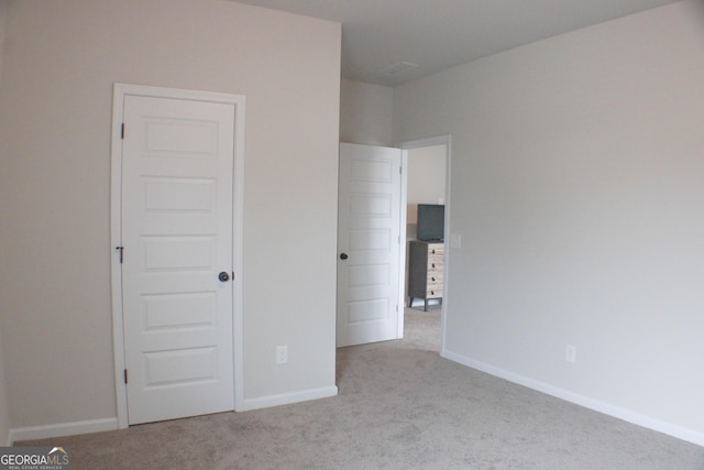 unfurnished bedroom featuring baseboards and carpet floors