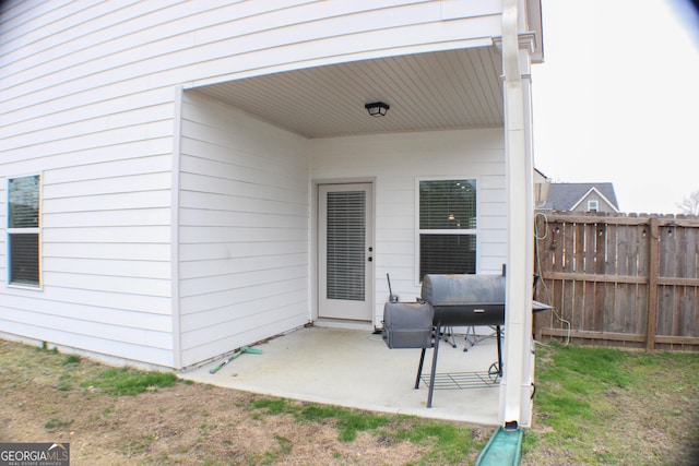 exterior space with area for grilling and fence