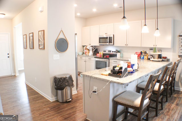 kitchen featuring dark wood-style floors, white cabinetry, and stainless steel appliances