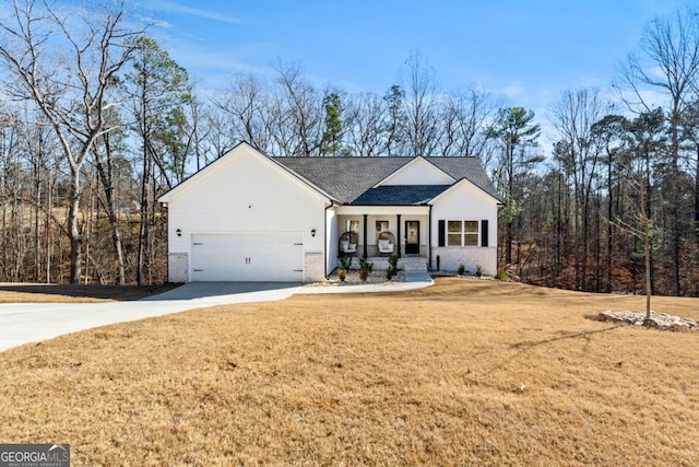 view of front of property with brick siding, a garage, concrete driveway, and a front lawn