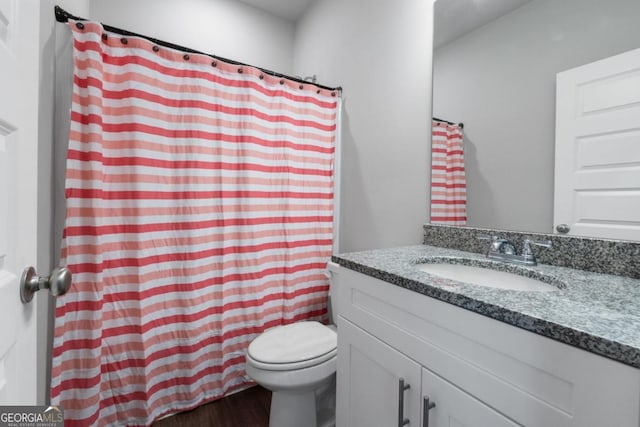 full bath with vanity, curtained shower, toilet, and wood finished floors