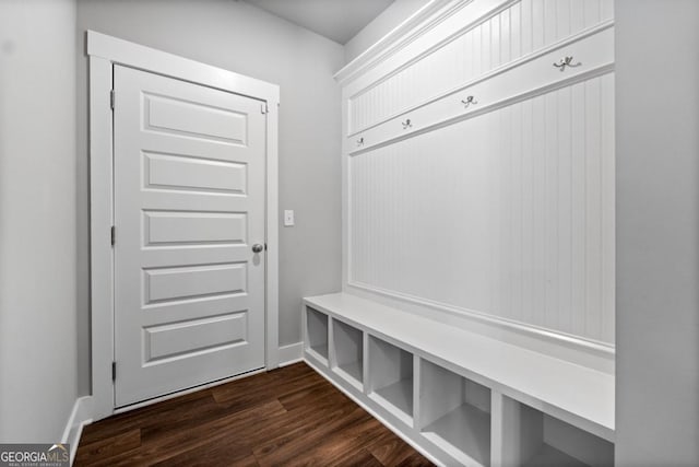 mudroom with dark wood-style floors and baseboards