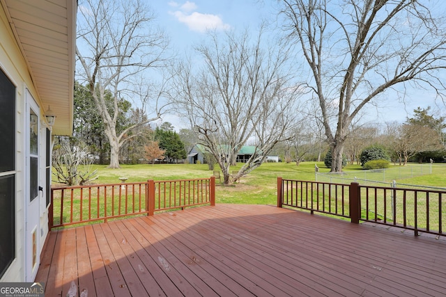 wooden terrace featuring a yard