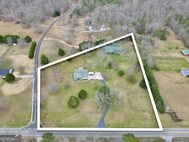 birds eye view of property with a rural view