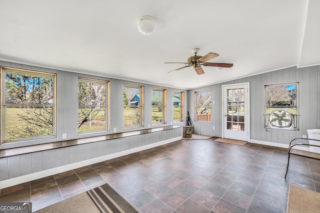 unfurnished sunroom with vaulted ceiling and a ceiling fan