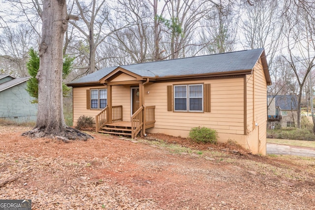 view of front of house with roof with shingles