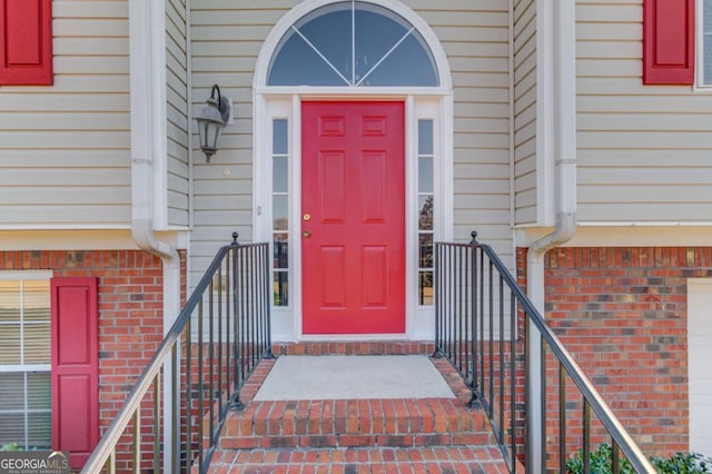 property entrance with brick siding