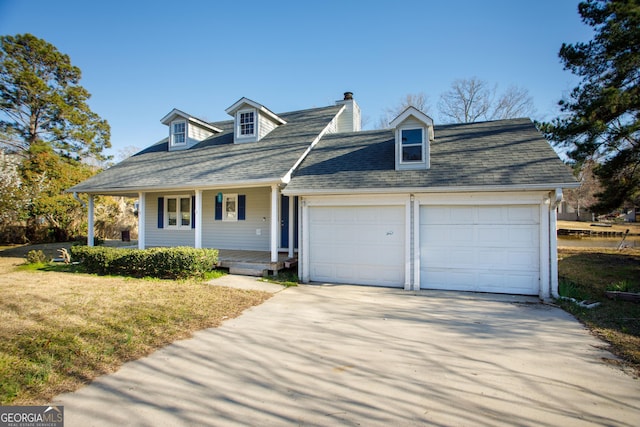 cape cod-style house with a chimney, covered porch, concrete driveway, and an attached garage