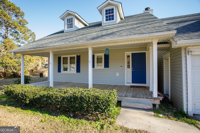 view of front facade with a porch and a shingled roof