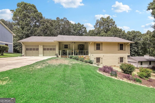 single story home featuring a porch, driveway, a garage, and a front yard