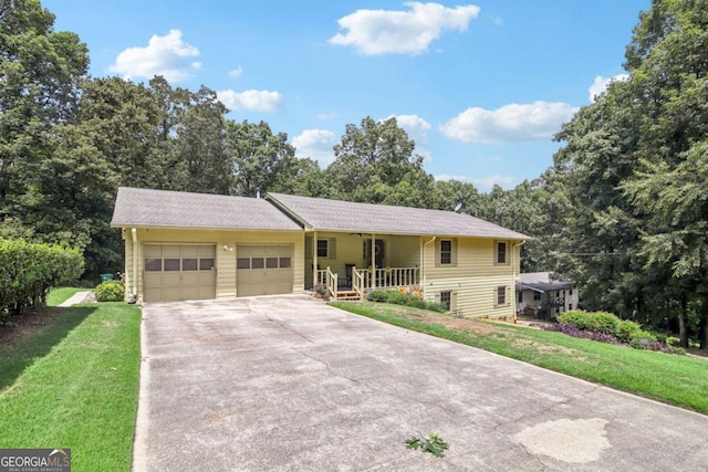 ranch-style home with covered porch, an attached garage, driveway, and a front yard