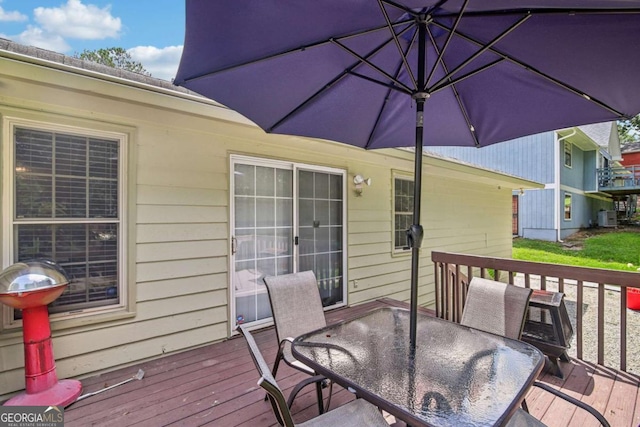 wooden terrace with outdoor dining area