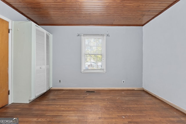 unfurnished bedroom with wood finished floors, baseboards, visible vents, a closet, and wooden ceiling