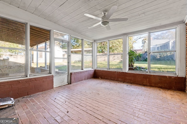 unfurnished sunroom with plenty of natural light, wood ceiling, and a ceiling fan