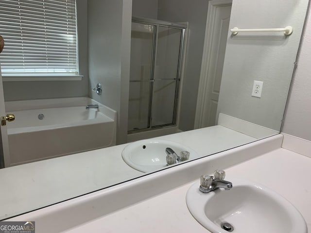 full bath featuring a bath, a shower stall, and a sink