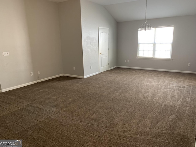 empty room with an inviting chandelier, baseboards, dark carpet, and vaulted ceiling