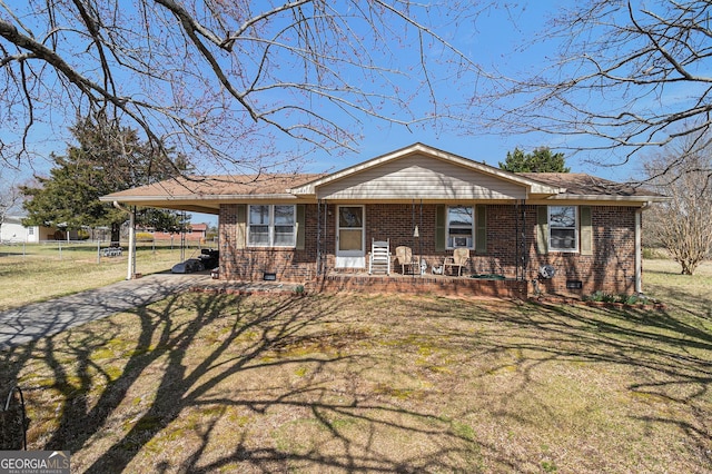 view of front facade with a porch, a front lawn, a carport, crawl space, and brick siding