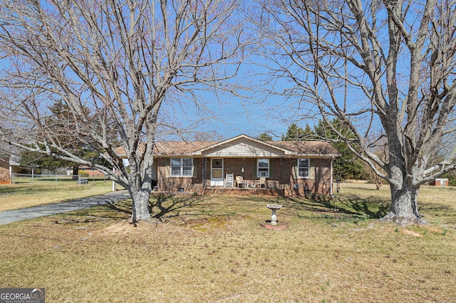 view of front of home with brick siding, crawl space, a porch, and a front yard