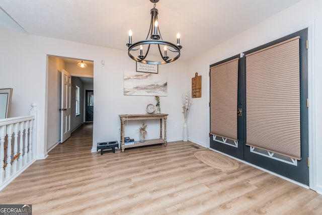 12701 Ga Highway 96 E, Fort Valley, GA 31030 - unfurnished dining area featuring a chandelier, wood finished floors, and french doors