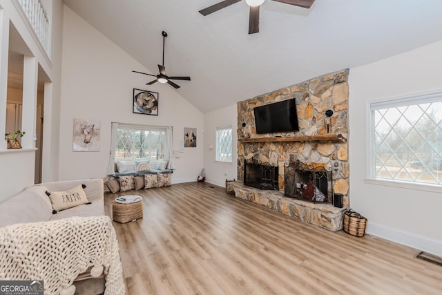 12701 Ga Highway 96 E, Fort Valley, GA 31030 - living room featuring ceiling fan, high vaulted ceiling, a fireplace, and wood finished floors