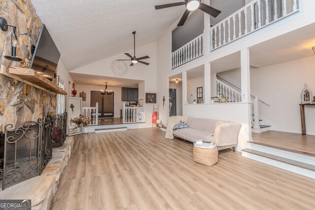 12701 Ga Highway 96 E, Fort Valley, GA 31030 - living room with a ceiling fan, wood finished floors, stairs, high vaulted ceiling, and a chandelier