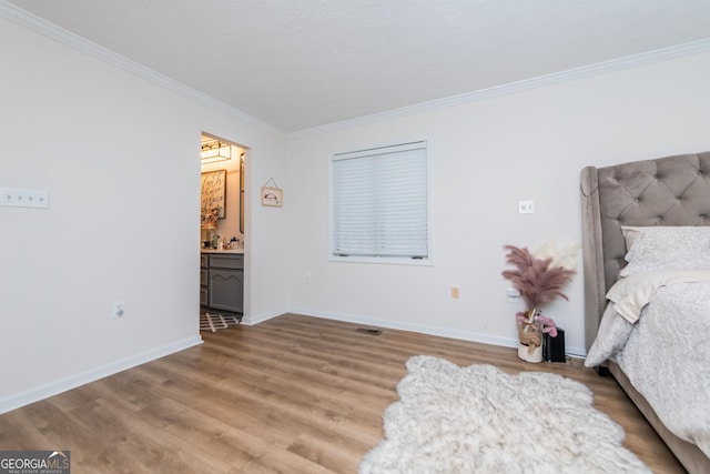 12701 Ga Highway 96 E, Fort Valley, GA 31030 - bedroom featuring ornamental molding, light wood-type flooring, and ensuite bathroom