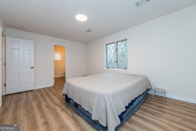 12701 Ga Highway 96 E, Fort Valley, GA 31030 - bedroom featuring light wood-style floors and a textured ceiling
