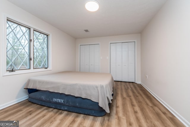 12701 Ga Highway 96 E, Fort Valley, GA 31030 - bedroom featuring two closets and wood finished floors