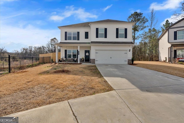 view of front of home with a front lawn, fence, a garage, and driveway