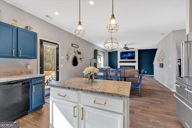 kitchen with visible vents, blue cabinetry, black dishwasher, dark wood-style floors, and a glass covered fireplace