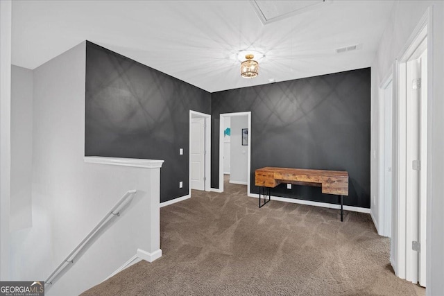 hall featuring an upstairs landing, visible vents, baseboards, and carpet floors