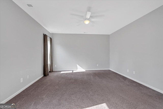 empty room featuring baseboards, carpet, and a ceiling fan