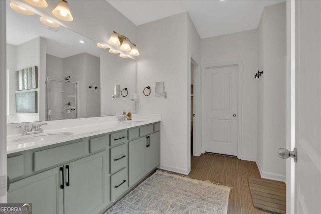 full bath featuring baseboards, a stall shower, and a sink