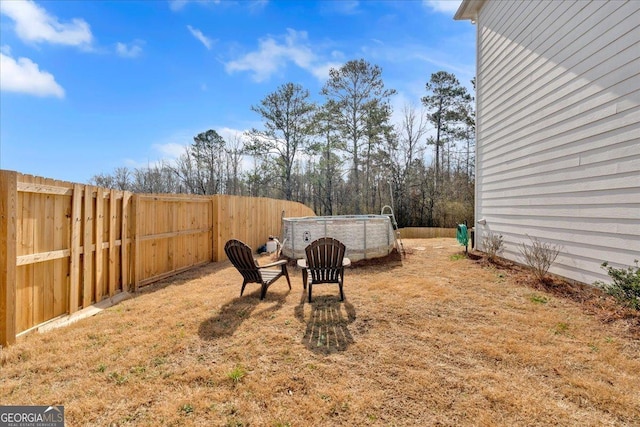 view of yard featuring a fenced in pool and a fenced backyard