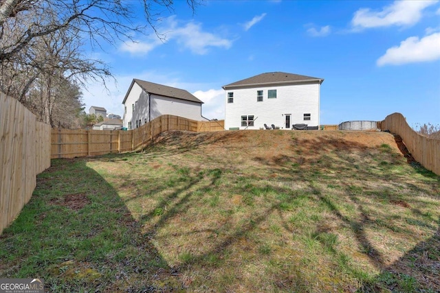 view of yard with a fenced backyard