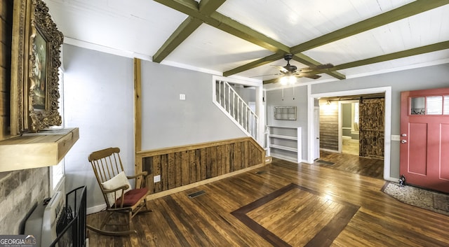 entryway featuring a barn door, stairway, hardwood / wood-style flooring, and beam ceiling