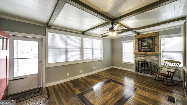 living room featuring visible vents, beam ceiling, hardwood / wood-style floors, a large fireplace, and baseboards