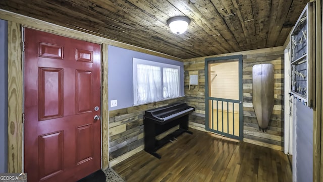 entrance foyer with wooden ceiling, wooden walls, and wood finished floors