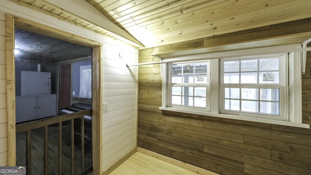 bathroom with wood finished floors, lofted ceiling, wood ceiling, and wood walls