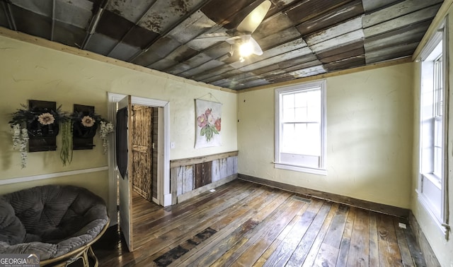 interior space with wooden ceiling, baseboards, ceiling fan, and wood-type flooring