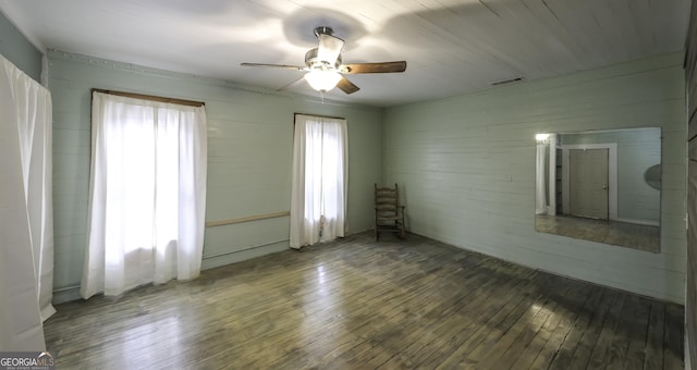 empty room with visible vents, ceiling fan, and hardwood / wood-style floors