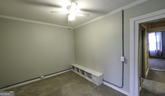 carpeted spare room featuring crown molding and a ceiling fan