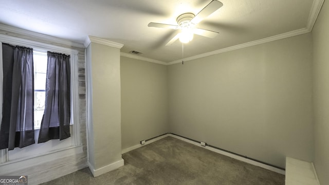 spare room featuring baseboards, visible vents, carpet floors, ceiling fan, and ornamental molding