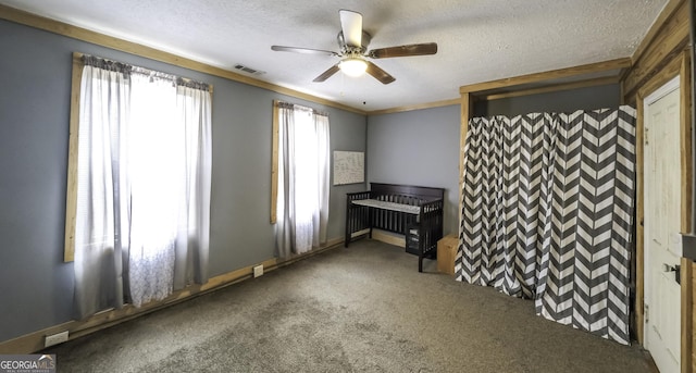 interior space featuring visible vents, a textured ceiling, ceiling fan, and carpet flooring