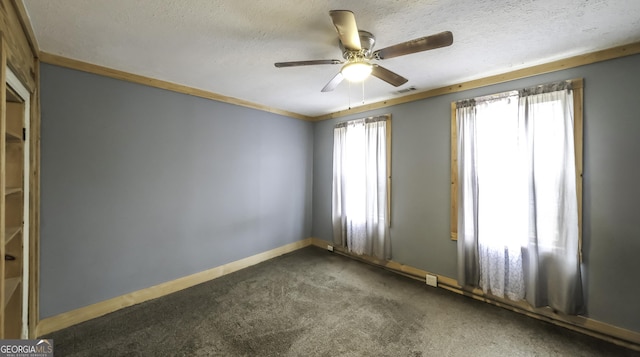 empty room featuring visible vents, baseboards, a textured ceiling, and dark carpet